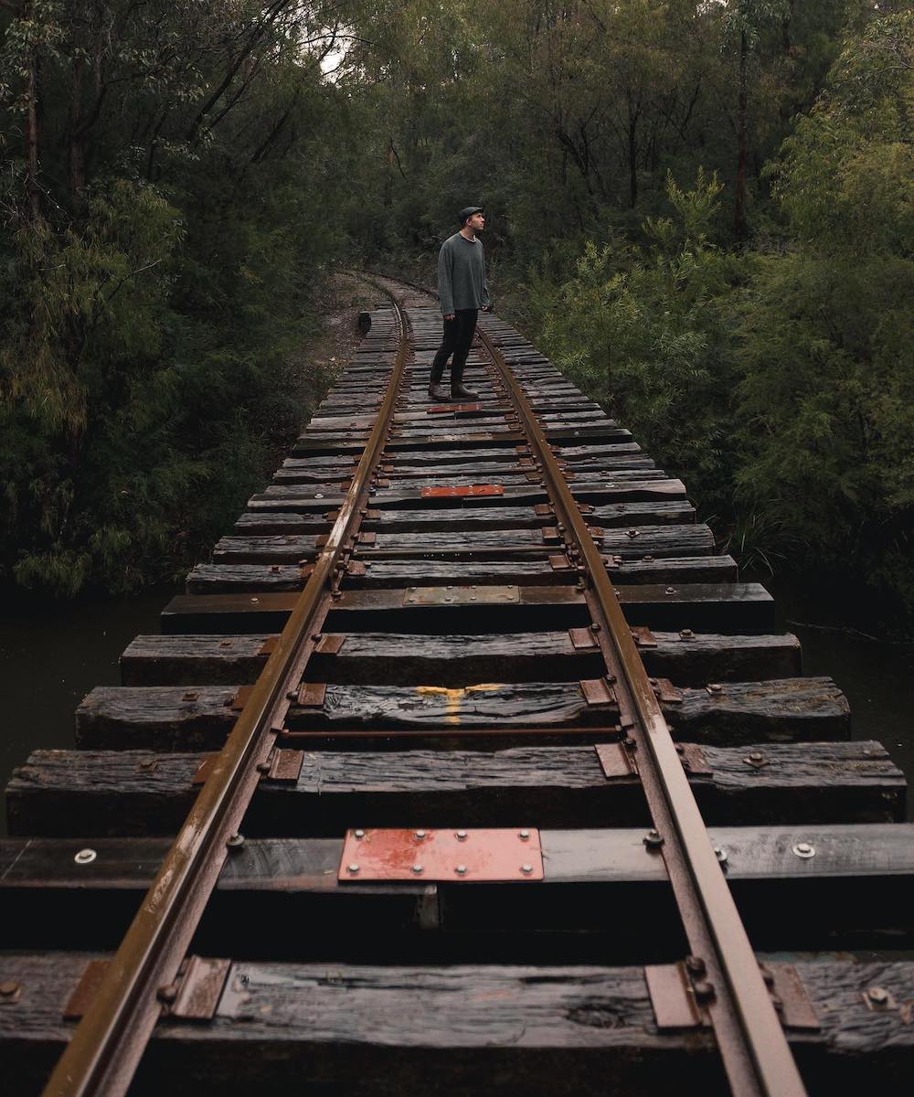 Someone exploring train tracks near Cascades in Pemberton