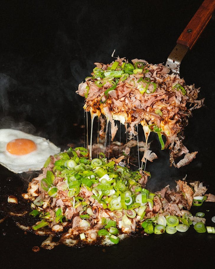 Cooking okonomiyaki on the grill. 