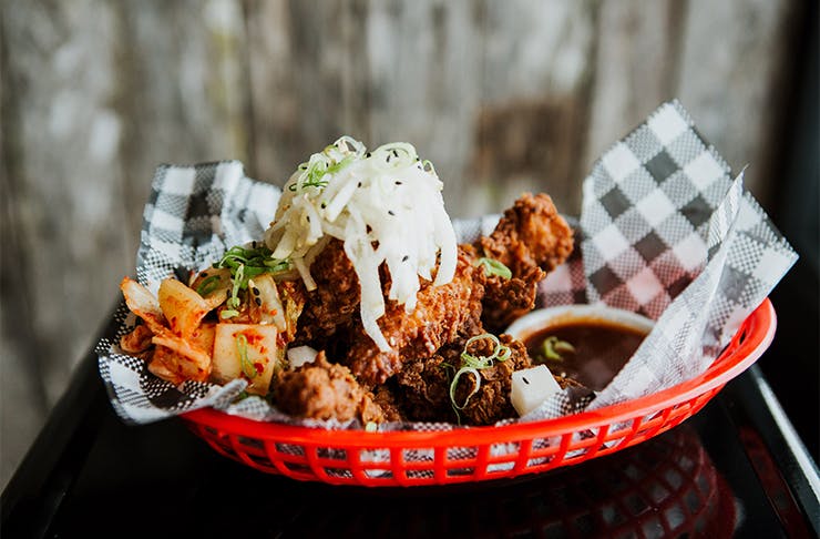 fried chicken wings in a red basket