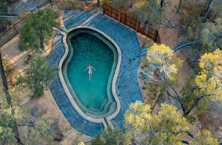 a woman in a pool seen from the air