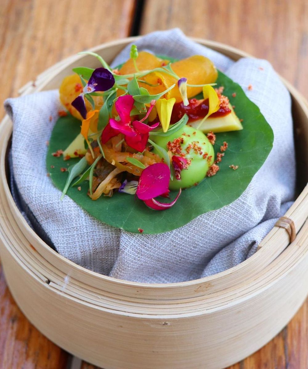 a bamboo steamer filled with pretty veggies
