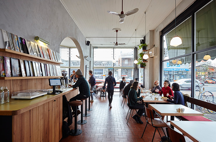 A waiter walking at a cafe, a best lunch Melbourne location. 