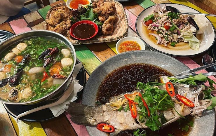 a table full of Thai food dishes