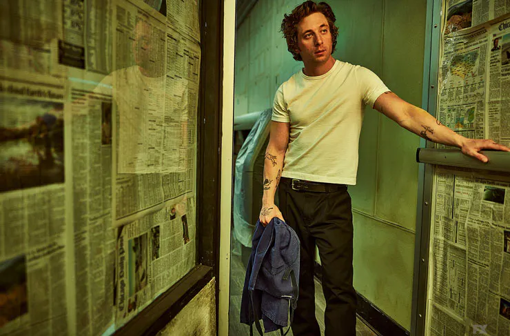 Actor Jeremy Allen White wears a white t-shirt and jeans in the hit TV series The Bear