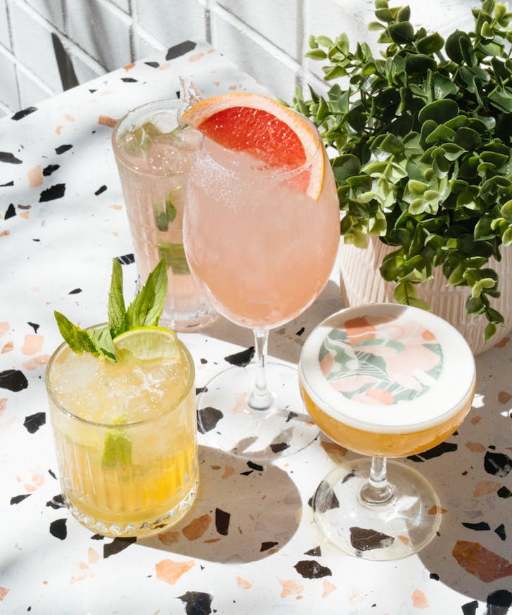 a terrazzo table topped with different cocktails