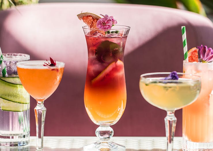 A lineup of brightly coloured cocktails. 