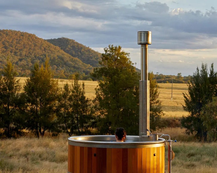 A view of the hot tub overlooking the countryside at The Creek one of the best NSW Airbnbs