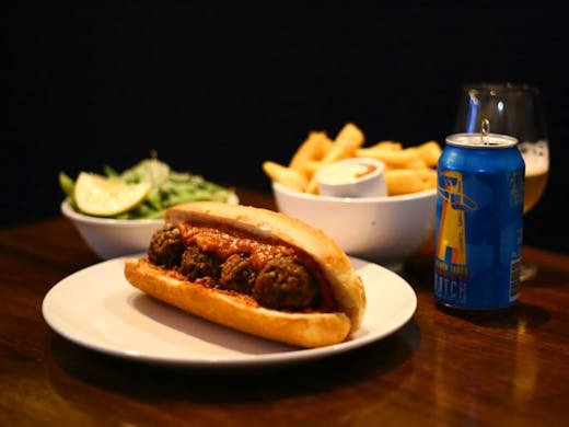 A vego meatball sub, hot chips and beer from The Sunshine Inn in Sydney. 