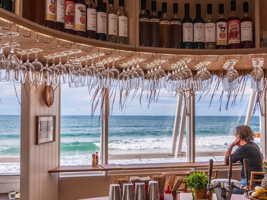 A Tiki inspired bar with views onto the beach and surf