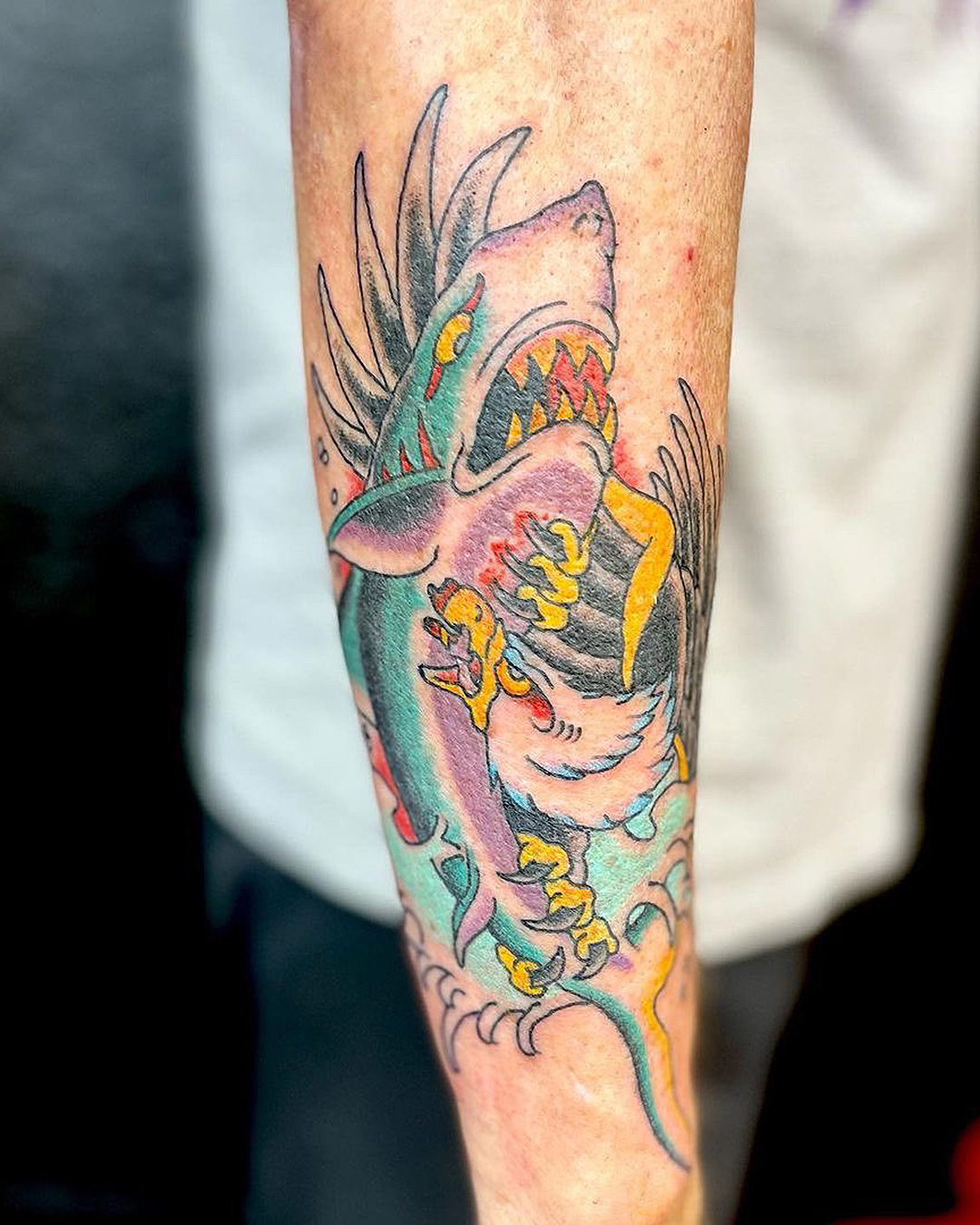 An eagle faces off with a shark in this tattoo from K'Road's tattooed heart.