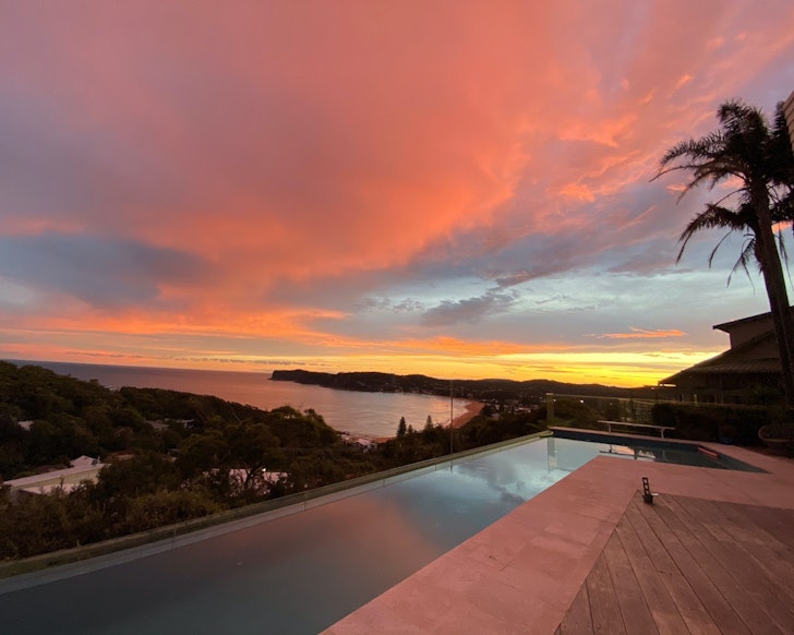 A view across the pool at sunset at The Vue Airbnb some of the best Central Coast accommodation
