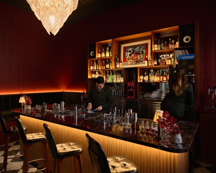 the deep red interior and colourful bar of tailor room at the collective in the rocks