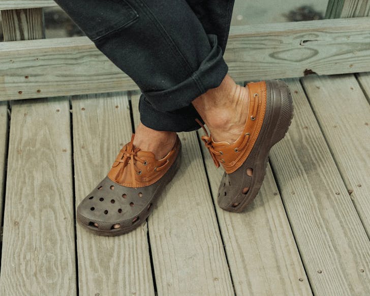 Close-up of someone's lower half modelling two-toned (grey bottom, burnt orange top)the Croats.