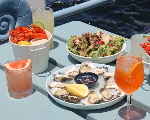 waterfront dining at the espy food oysters prawns aperol spritz on a picnic table