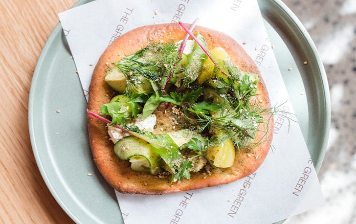 avo and herbs on flatbread