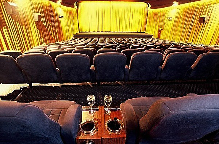 A luxurious theatre which includes seats with wine holders