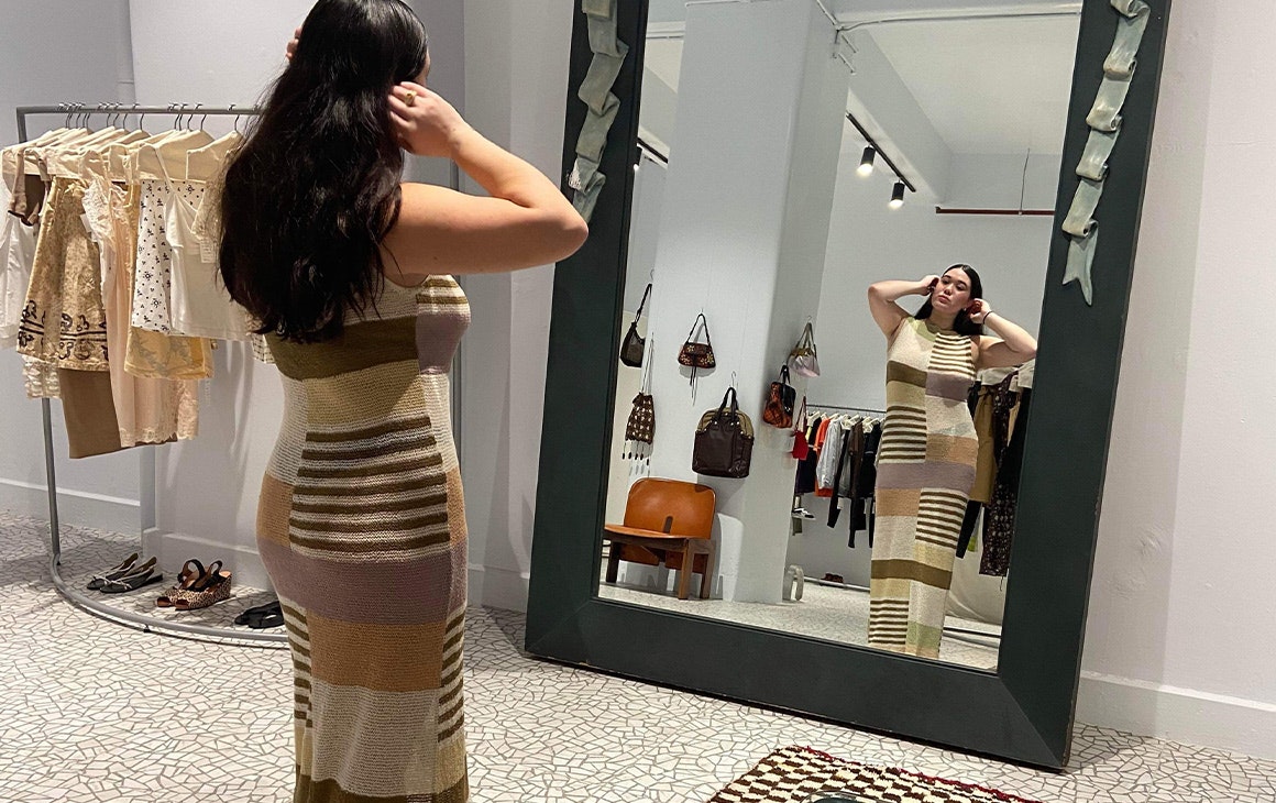 a woman standing in front of a mirror