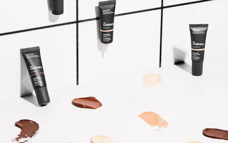 several tubes of concealer on a counter