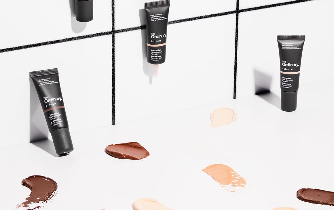 several tubes of concealer on a counter