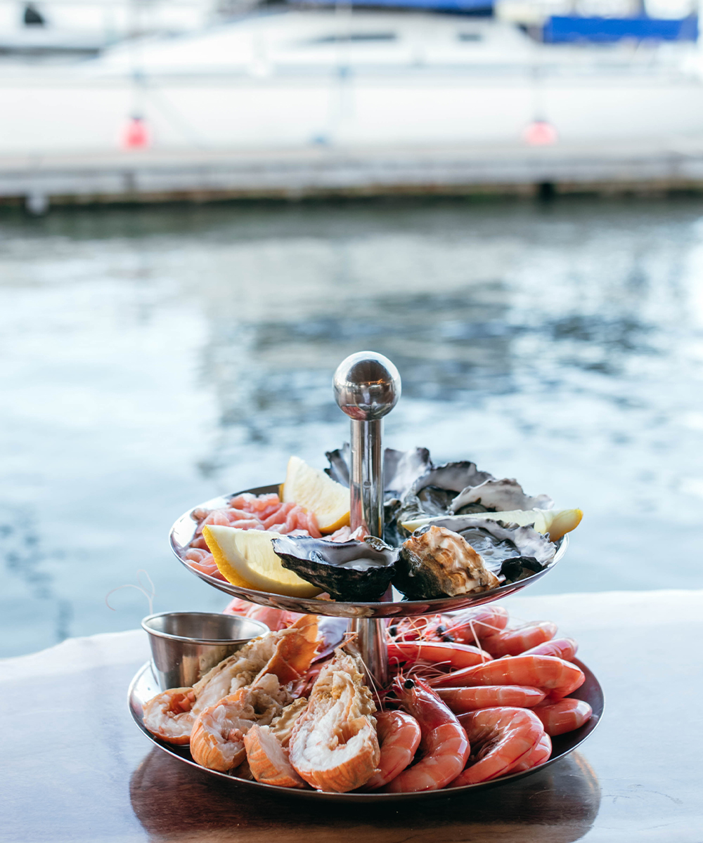 a platter of seafood in front of water