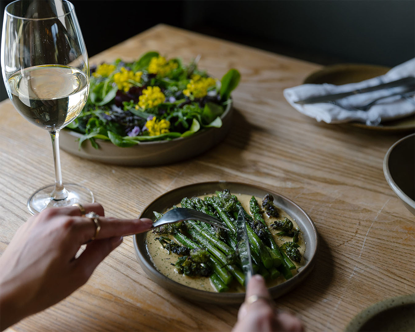 Someone tucks into a hearty plate of greens at The Sherwood, one of the best restaurants in Queenstown.