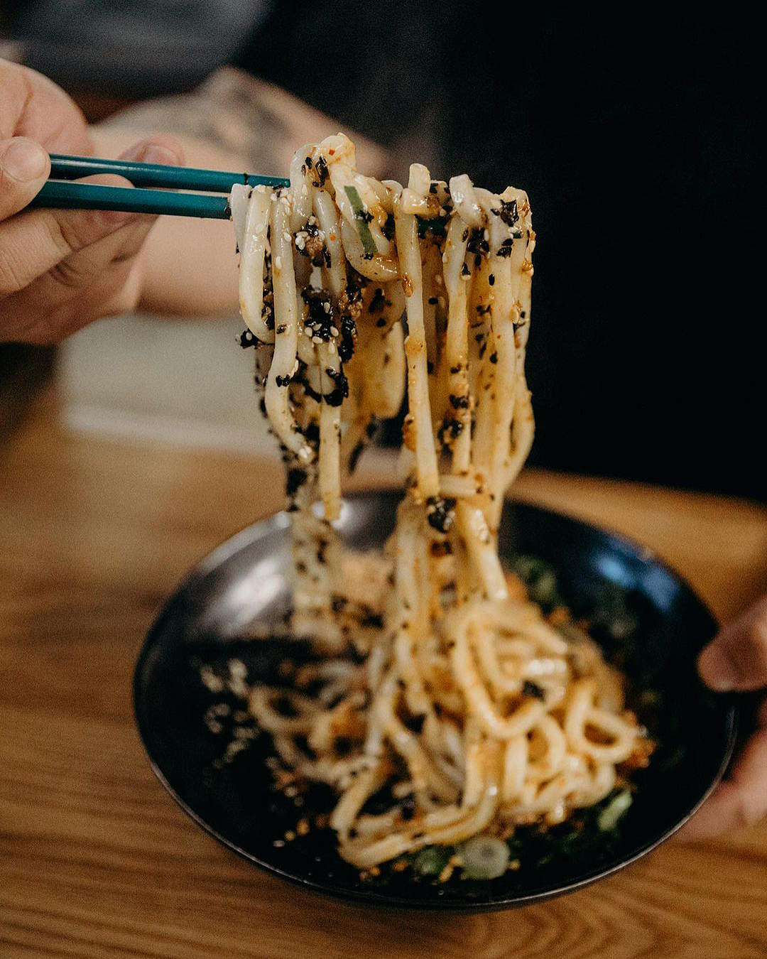 A noodle dish looks incredibly moreish held between chopsticks.