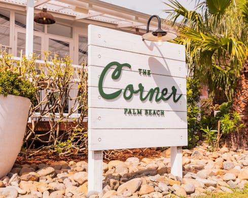the corner palm beach sign