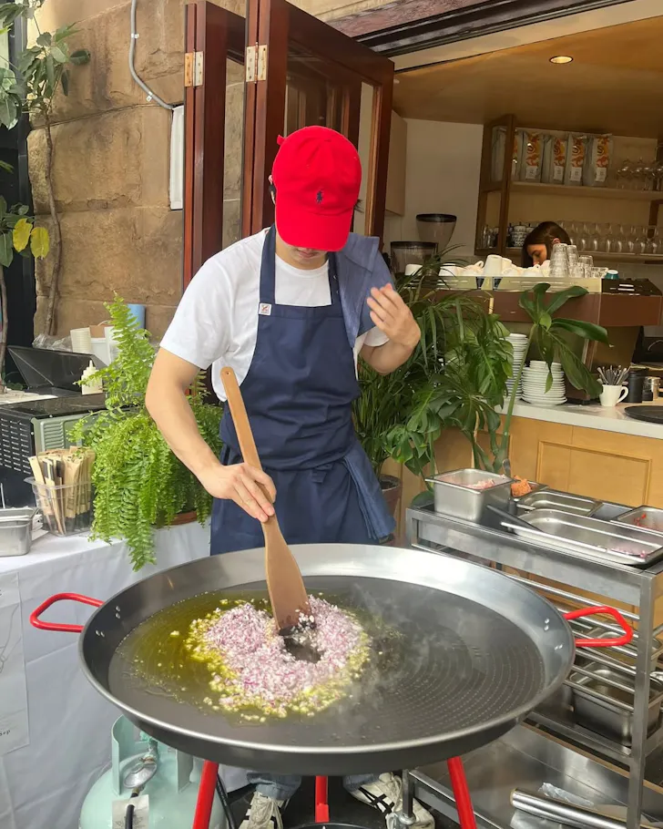A chef cooks paella for THEECA's Winter Grill Nights