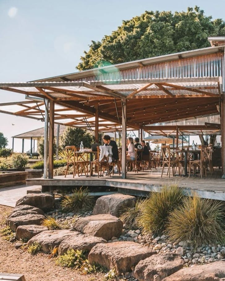 A large, wrap-around outdoor patio at restaurant Three Blue Ducks on The Farm.