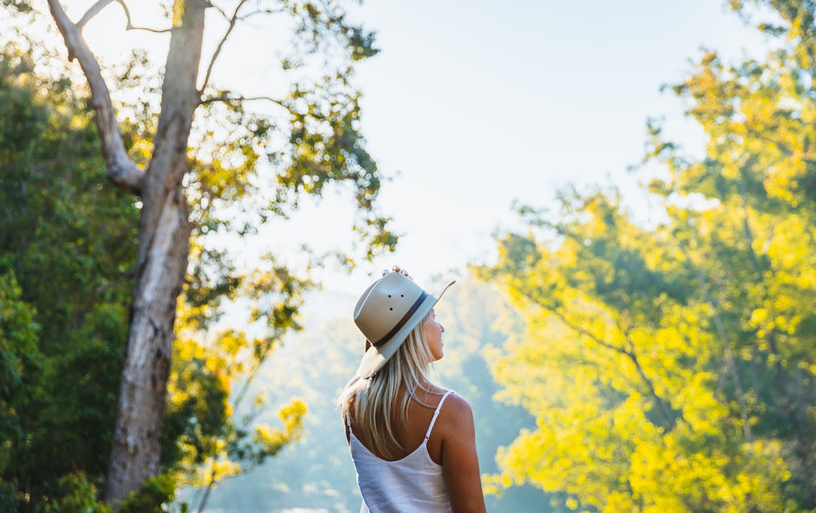 a woman staring into the forest
