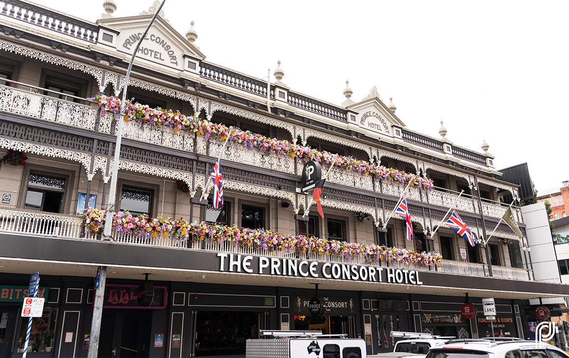 the front facade of The Prince Consort, with fretwork verandahs covered in flowers