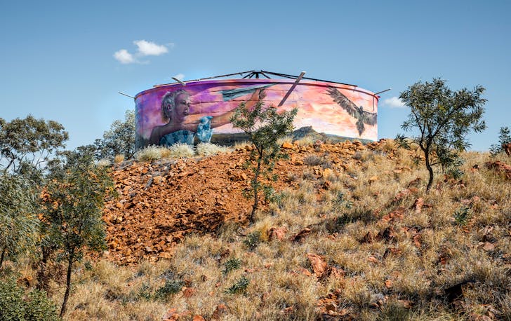 a water tower painted with a mural