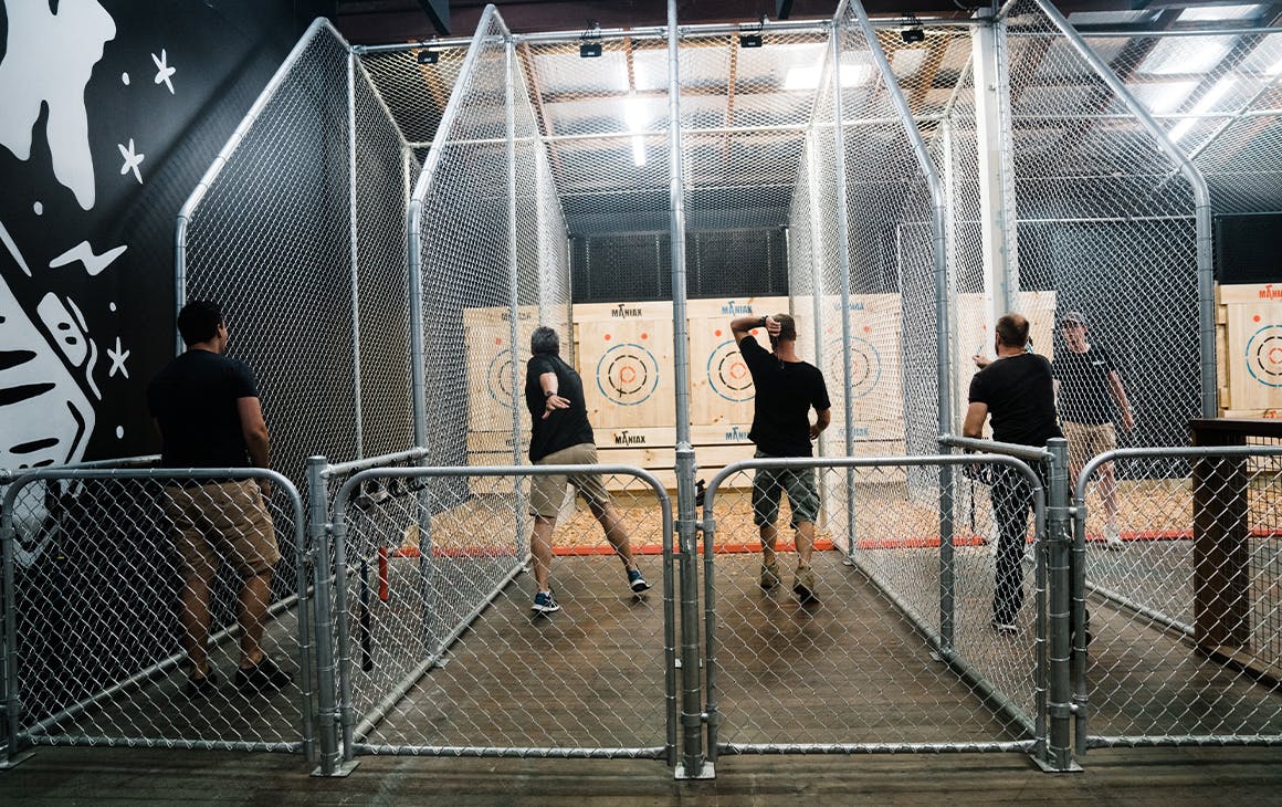 several men throwing axes at targets at Maniax, an idea for Father's Day in Brisbane