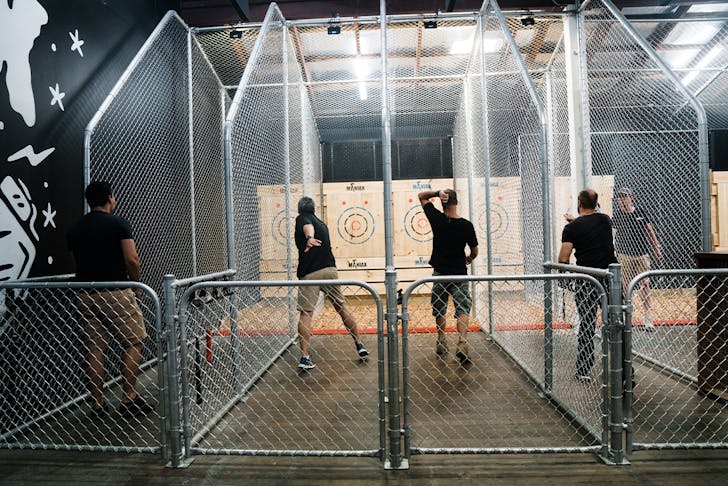 several men throwing axes at targets at Maniax, an idea for Father's Day in Brisbane