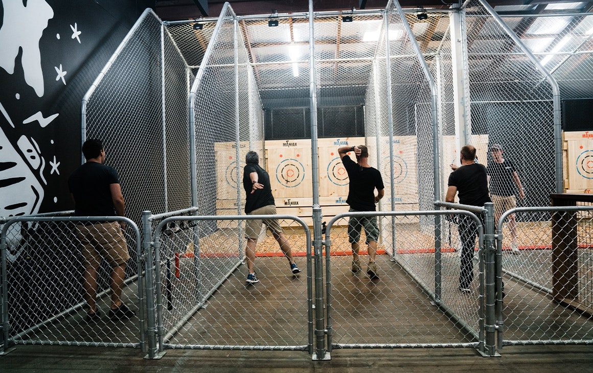 several men throwing axes at targets at Maniax, an idea for Father's Day in Brisbane