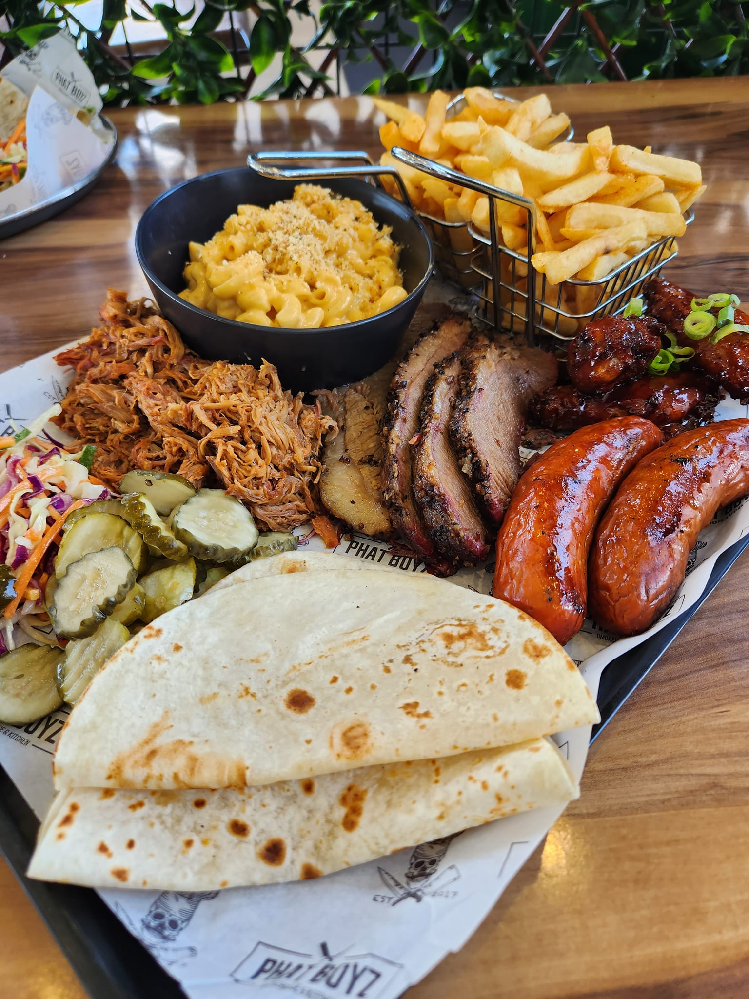 a large platter of bbq meats and side