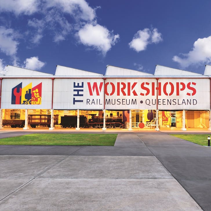 a large warehouse with an old train visible inside