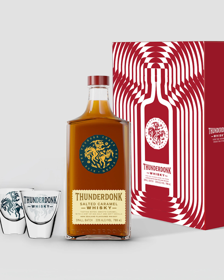 A bottle of ThunderBonk next to two shot glasses and a red gift box.