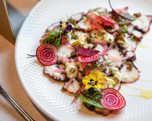 a plate of octopus carpaccio