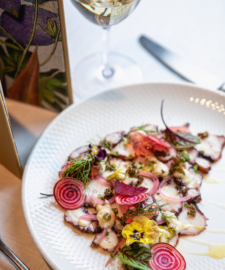 a plate of octopus carpaccio