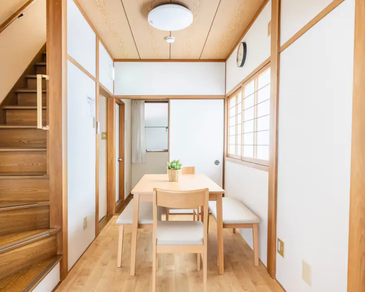 A light-filled, timber dining area of a beautiful, minimalist Airbnb in Osaka