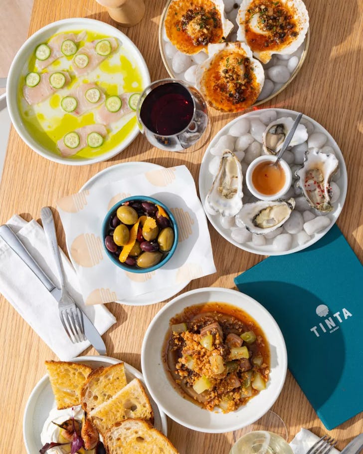 A spread of seafood-heavy dishes at Tinta Belmont
