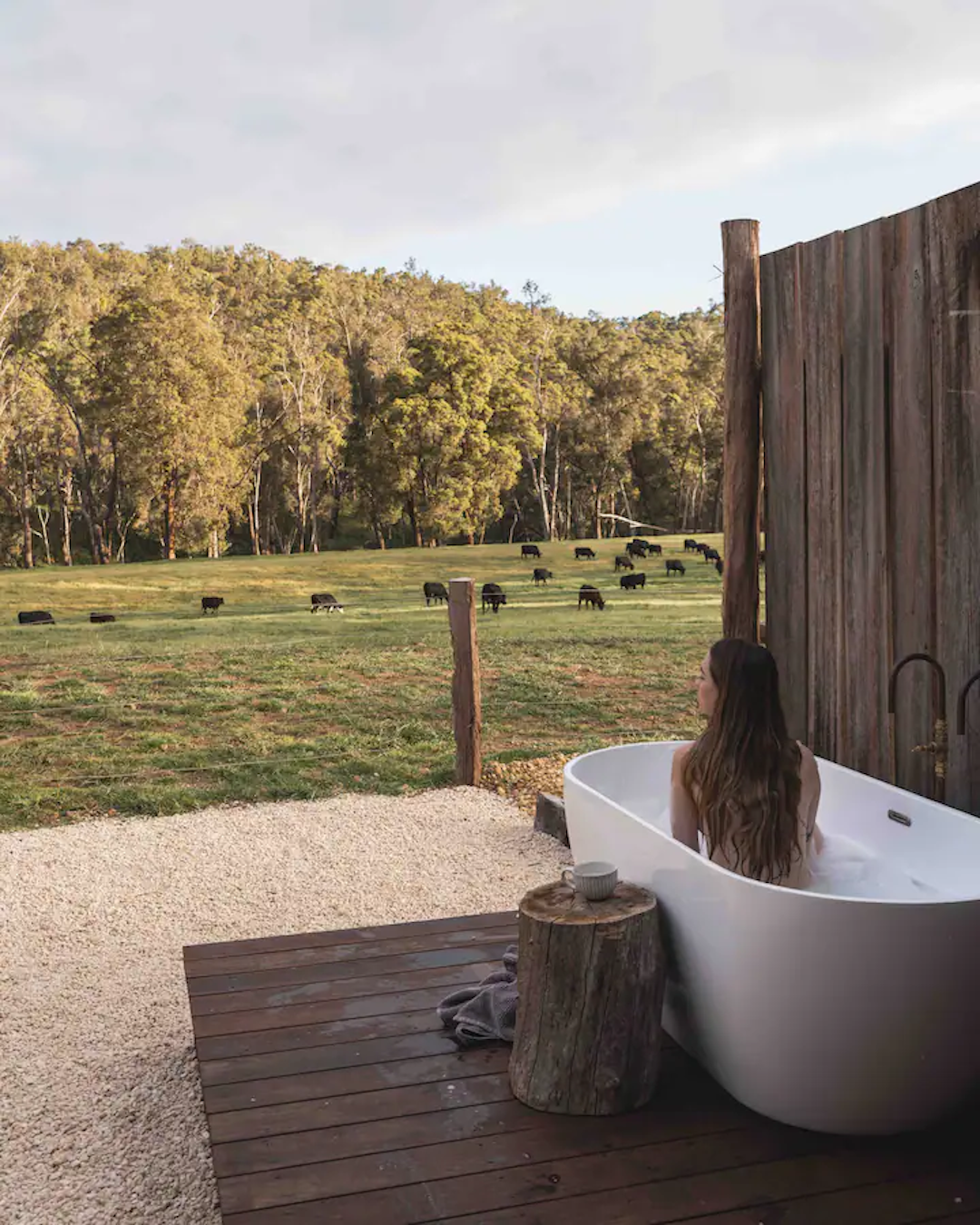 Someone enjoying an outdoor bath at a tiny home