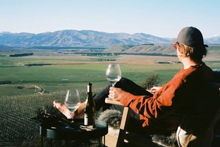 Someone enjoys the view with a glass of wine at Pisa Cabin on the hill.