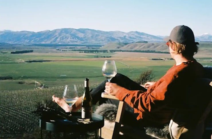 Someone enjoys the view with a glass of wine at Pisa Cabin on the hill.