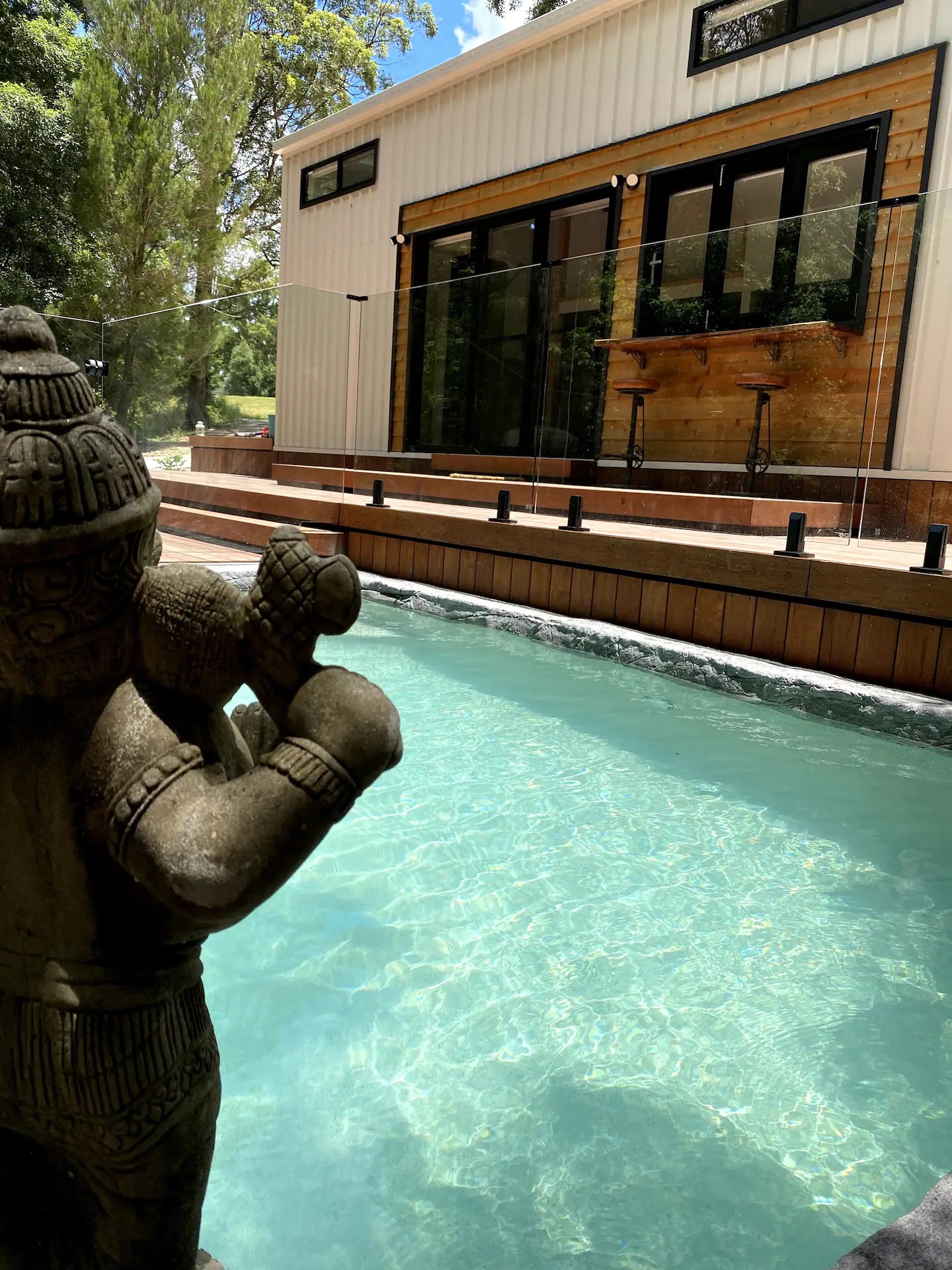 buddha statue overlooking a pool