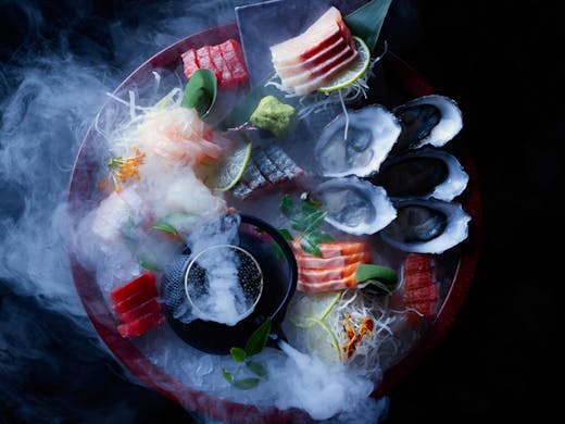 A plate of sashimi and oysters from Toko. 