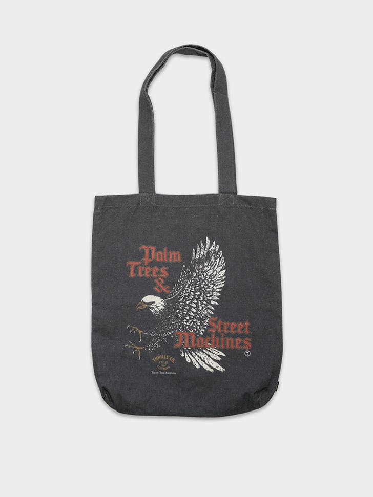 A black tote bag with an eagle on it. 