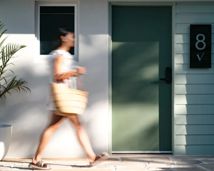 A woman walking by her room door at victoria street boutique hotel townsville