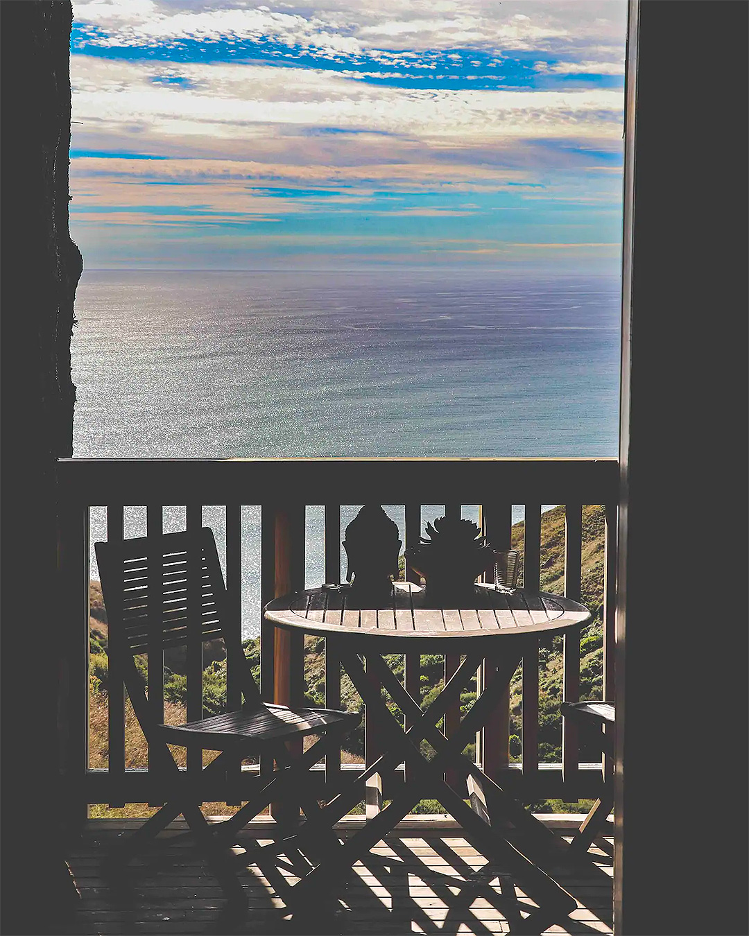 A view over the sea from the stunning treehouse in the woods, one of the best romantic getaways from Auckland.